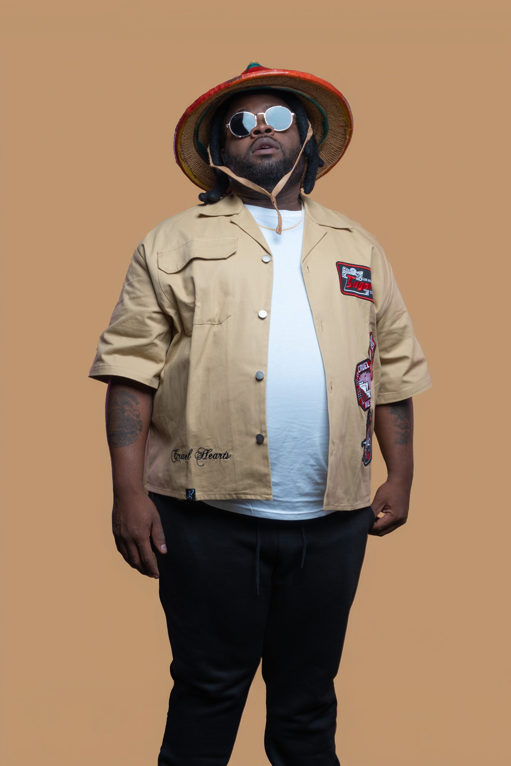 woman in blue long sleeve shirt and brown pants sitting on white concrete wall